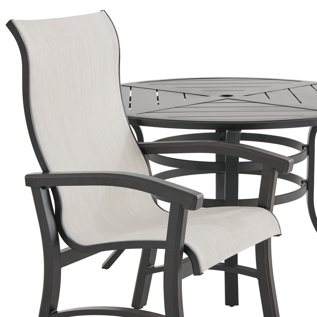 Close-up of one beige sling chair and table edge