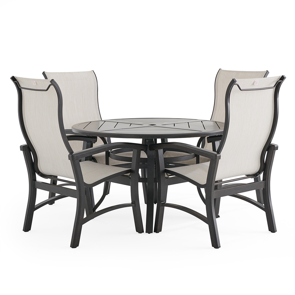 Angled view of round dining table with chairs