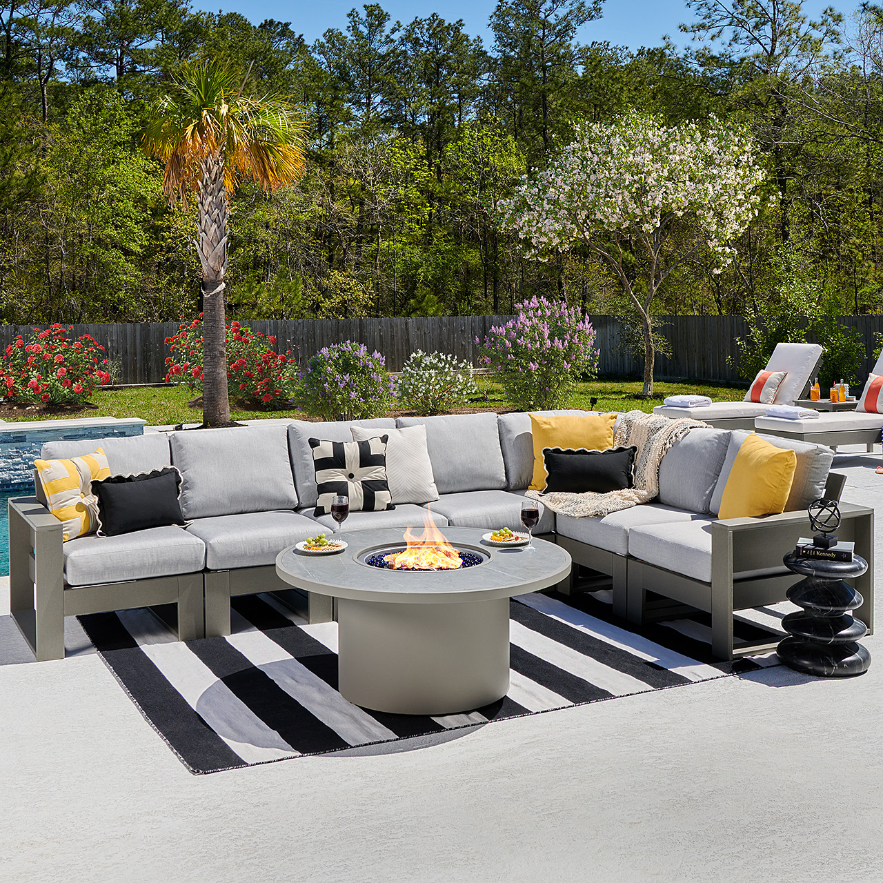 Montauk Slate Grey Polymer with Cushions 8 Piece Modular Sectional + 48 in. D Sintered Fire Pit Table