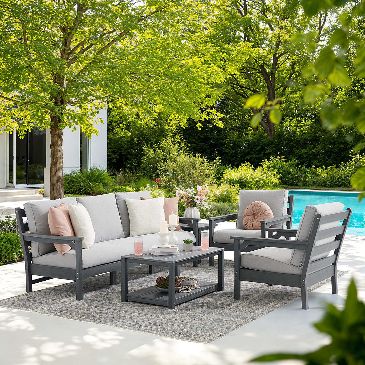 4-piece polymer outdoor furniture set by a pool