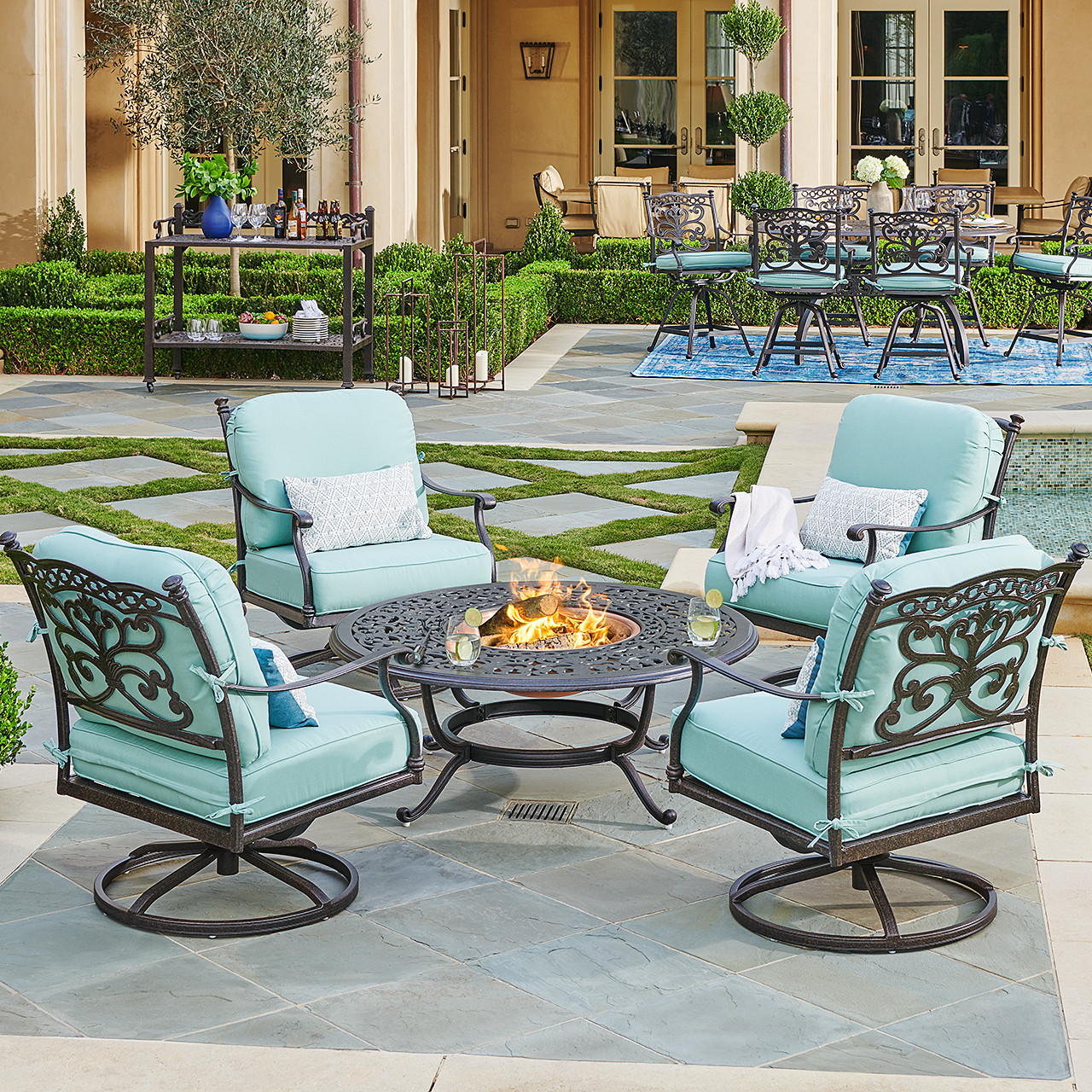 Milan Aged Bronze Cast Aluminum and Spectrum Mist Cushion 5 Pc. Swivel Rocker Chat Group with 48 in. D Fire Pit Table