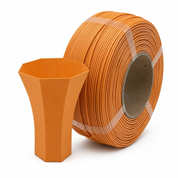 Matte orange 3D printer filament roll standing on edge with a matching orange 3D printed vase placed in front on a white background.