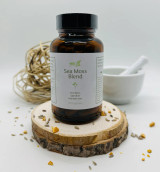 Abeca Naturals Sea Moss Blend 100-count bottle, herbal supplement with Irish Moss, Spirulina, and Red Beet Root, displayed on a wooden slice with lavender buds, citrus peel, and natural decor.