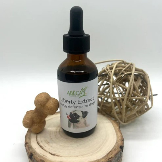 Abeca Naturals Liberty Extract 2 oz allergy defense tincture for dogs, shown in a dropper bottle with a dog bone treat and natural wooden decor Abeca Naturals Liberty Extract 2 oz allergy defense tincture for dogs, shown in a dropper bottle with a dog bone treat and natural wooden decor
