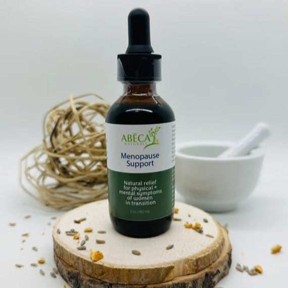 Abeca Naturals Menopause Support Tincture 2 oz bottle, an herbal blend for hot flashes, night sweats, and mood balance, displayed on a wooden slice with lavender buds, citrus peel, and natural decor in the background. Abeca Naturals Menopause Support Tincture 2 oz bottle, an herbal blend for hot flashes, night sweats, and mood balance, displayed on a wooden slice with lavender buds, citrus peel, and natural decor in the background.