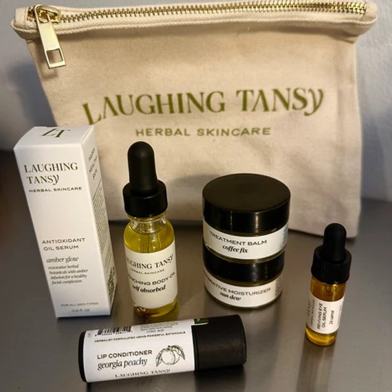 Laughing Tansy Herbal Skincare Large Sample Kit with cosmetic pouch, featuring Amber Glow Antioxidant Oil Serum, Self Absorbed Quenching Body Oil, Coffee Fix Treatment Balm, Sun Dew Reviving Moisturizer, Georgia Peachy Lip Conditioner, and 24 Carrot Oil Eye Serum. Laughing Tansy Herbal Skincare Large Sample Kit with cosmetic pouch, featuring Amber Glow Antioxidant Oil Serum, Self Absorbed Quenching Body Oil, Coffee Fix Treatment Balm, Sun Dew Reviving Moisturizer, Georgia Peachy Lip Conditioner, and 24 Carrot Oil Eye Serum.