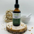 Abeca Naturals Nature’s Happy 2 oz tincture bottle, mood-enhancing herbal blend with St. John’s Wort, Chamomile, Motherwort, and Marshmallow, displayed on a wooden slice with lavender buds, citrus peel, and natural decor.