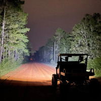 dual wide 8" led headlights for Honda Pioneer from Vessel Power Sports powder coated black showing how bright they are