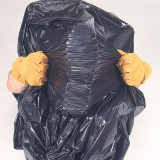 Premium black trash bag stretched to demonstrate durability