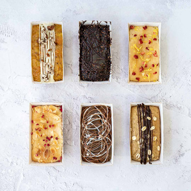 Thinking of You Classic Cake Box | Vegan, Eggless, Gluten Free Cakes Delivered | Positive Bakes Cakes fit for royalty! We have handcrafted a gorgeous gift box filled with a selection of incredibly delicious vegan and gluten-free bakes! Six mini loaf cakes, each a much-loved and well-known flavour delivered with a thinking of you sleeve! In this box you will get - refreshing Lemon Drizzle, sweet Raspberry Bakewell, indulgent Chocolate & Salted