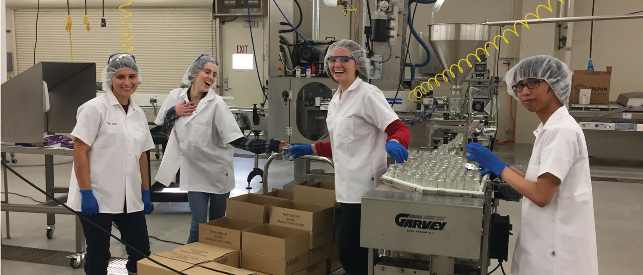 Cal Poly student employees filling jam jars