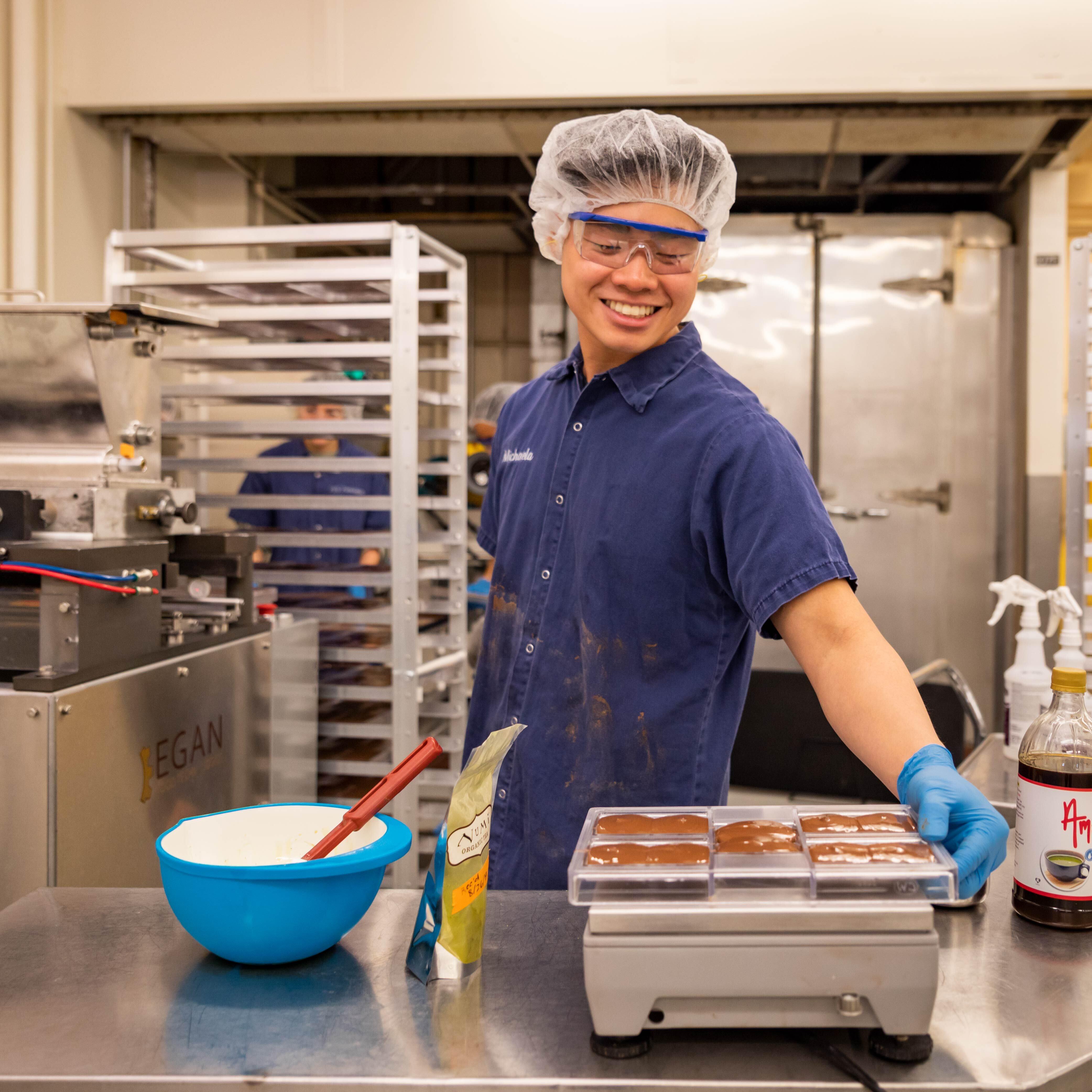 Cal Poly student employee working in the Food Science and Nutrition pilot plant