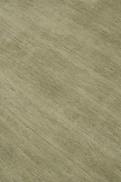 Close-up of Caliche Silk rug in Moss, showing lustrous silk sheen