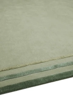 Arc rug in Spruce, studio detail shot showing the raised, layered silk border