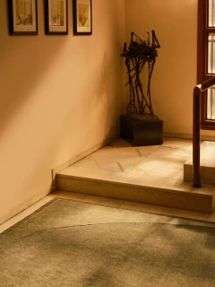 Doma rug in Forest, styled vignette in a stone entryway with a sculptural accent