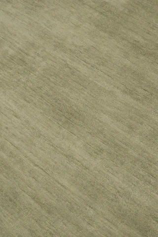 Close-up of Caliche Silk rug in Moss, showing lustrous silk sheen