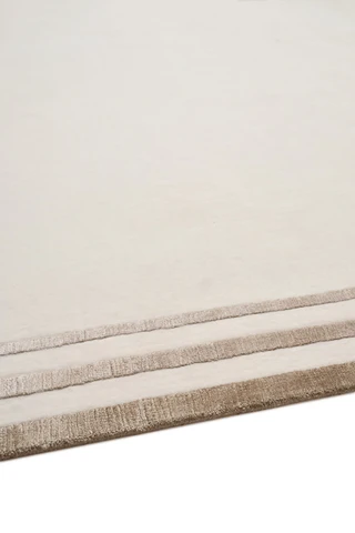 Portico rug in Birch, studio detail shot showing the raised, layered silk border