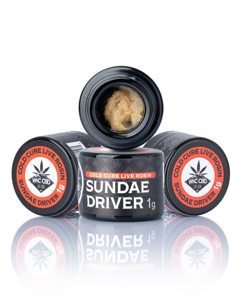 Sundae Driver Cold Cure Live Rosin, creamy texture, pale yellow, in black jars with labeled lids.