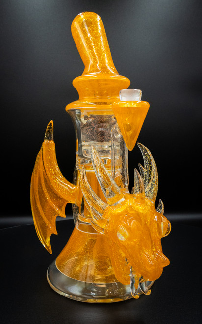 Scoz x Subliminal Golden Dragon Pillar, orange glass dragon-shaped accessory with horns and wings, shimmering finish. Scoz x Subliminal Golden Dragon Pillar, orange glass dragon-shaped accessory with horns and wings, shimmering finish.