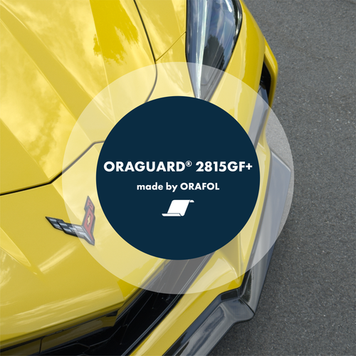 Close-up of ORAGUARD® 2815GF+ Paint Protection Film roll with glossy finish reflecting light, showcasing the film's clarity and thickness.