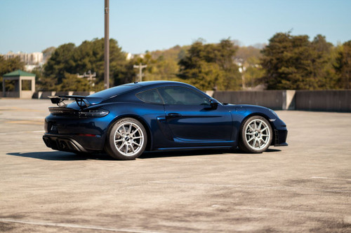 A Porsche is expertly wrapped in the KPMF K75400 Gloss Blue Black Iridescent Vinyl, creating a bold, futuristic appearance. The iridescent wrap changes from blue to black as the angle of light shifts, emphasizing the sleek lines and contours of the Porsche. The gloss finish delivers a mirror-like sheen, adding depth and dimension to the car’s exterior, making it stand out on the road with its vibrant, shifting color palette.