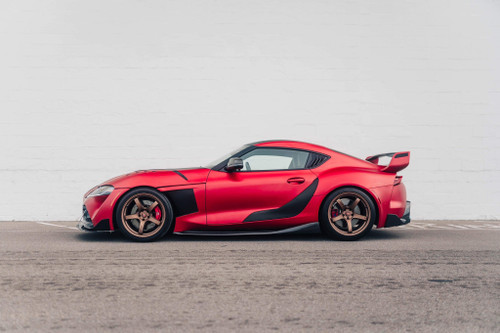 A Toyota Supra wrapped in KPMF K75500 Matte Iced Red Titanium vinyl sits in a modern garage, its body radiating a deep, matte red metallic sheen that enhances the car’s iconic curves and aggressive stance. The wrap hugs every contour of the Supra, from the aerodynamic hood to the rear spoiler, creating a high-performance look that combines luxury with speed. The Iced Red Titanium finish adds a unique, striking appearance to the sports car, making it a true head-turner even at a standstill.