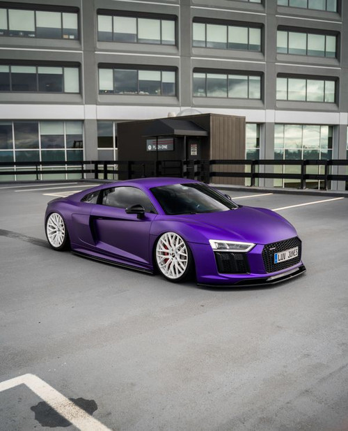 Audi R8 in Matte Iced Amethyst Titanium: A sleek Audi R8 wrapped in KPMF’s Matte Iced Amethyst Titanium film, showcasing a deep, matte purple finish with subtle metallic undertones. The wrap enhances the Audi's aerodynamic lines, creating a striking contrast with the car's iconic curves and aggressive stance. The light catches hints of titanium in the amethyst shade, giving the vehicle a luxurious, sophisticated look that’s both eye-catching and elegant. Perfectly applied with air-release technology, the wrap appears seamless across the R8’s flat and contoured surfaces.