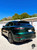 BMW i8 wrapped in KPMF K75400 Gloss Green Black Iridescent Vinyl Wrap. This stunning iridescent wrap shifts between green and black under different lighting, enhancing the sleek design of the BMW i8 with a high-gloss finish that stands out. Perfect for full car wraps, this premium double-cast vinyl offers excellent conformability and a dynamic look.