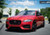 A Mercedes SUV wrapped in KPMF K75500 Matte Iced Red Titanium vinyl cruises down a city street, showcasing its sleek, matte metallic finish that glistens subtly under the streetlights. The bold Iced Red Titanium color contrasts beautifully against the SUV’s strong lines and contours, accentuating its luxury design. The wrap seamlessly covers the entire body, from the hood to the roof and doors, delivering a smooth, sophisticated look that highlights the vehicle’s elegant, robust presence on the road.