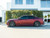 A Dodge Charger wrapped in KPMF Absolute Matte Mythos Red vinyl, showcasing the deep, dramatic red color and smooth, non-reflective matte finish that enhances the muscle car's aggressive lines.