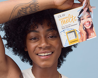 Sha'Carri Richardson U.S. Olympian holding a box of Olay Cleansing Melts + Vitamin C over her head