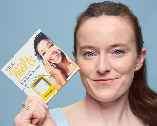 Rose Lavelle U.S. Olympian holding a box of Olay Cleansing Melts + Vitamin C beside her face