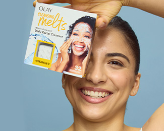 Natalia Grossman U.S. Olympic Hopeful holding a box of Olay Cleansing Melts + Vitamin C over her face