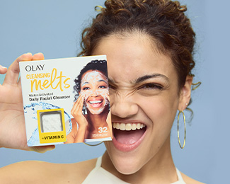 Laurie Hernandez U.S. Olympian holding a box of Olay Cleansing Melts + Vitamin C over her face