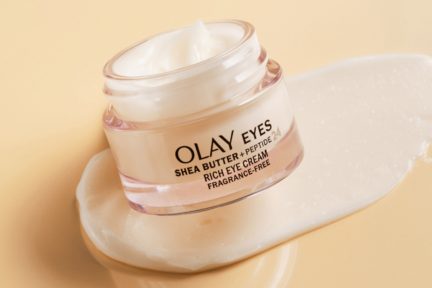 Olay Shea Butter Peptide 24 rich eye cream with open lid on top of a swipe of the cream