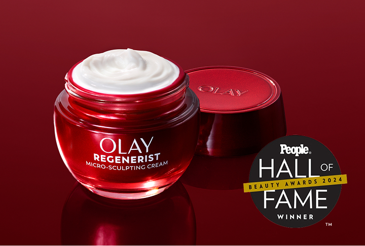 Brilliant red glass jar of Olay Micro-Sculpting Cream moisturizer with its lid removed and cream exposed alongside a People magazine Hall of Fame Winner award badge.