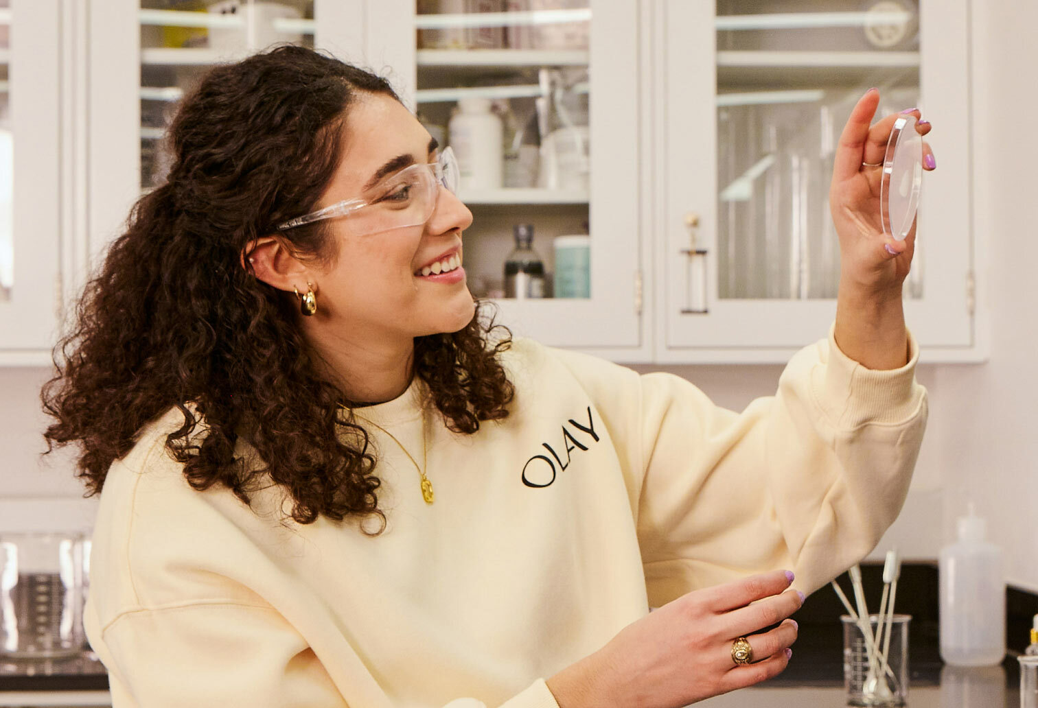 One female scientist examing petri dish in laboratory