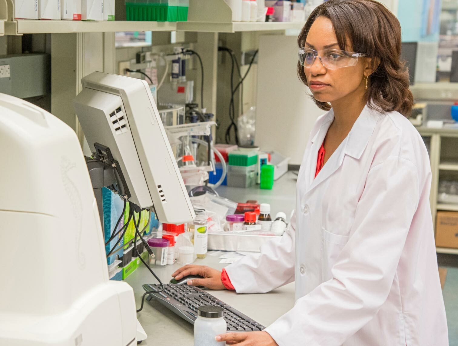 Female scientist in laboratory working on a computer