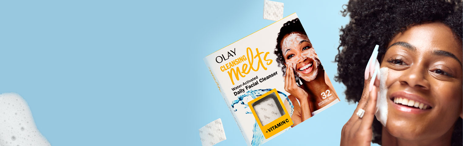 African American woman lathering her cheek with the new Olay Cleansing Melts