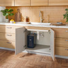 Brondell Circle RC100 Reverse Osmosis System installed beneath the sink in a warm modern kitchen, demonstrating its compact under-counter design.