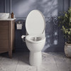 PureSpa Ergonomic Bidet Attachment with Dual Nozzles on a white toilet in a blue bathroom beside a wood vanity.