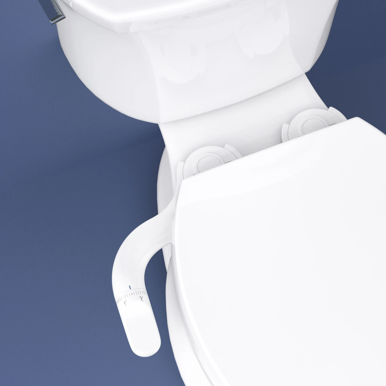 Overhead view of the PureSpa Ergonomic Bidet Attachment with Dual Nozzles installed beneath a white toilet seat.