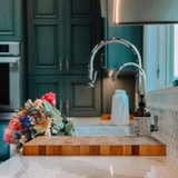 Sequoia water filter faucet in brushed nickel installed in sink with beautiful flower arrangement.