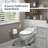 Modern bathroom with high-tech toilet featuring Brondell Swash 1000 Swash 1000
Luxury Bidet Toilet Seat with Remote Control. Shelf above holds decor; window with shutters lets in natural light. Copy reads a luxury bathroom experience.