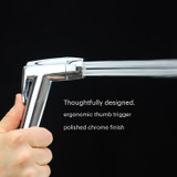 Brondell CleanSpa easy hand-held bidet sprayer shown in action with thumb depressed on hand-held bidet with water spraying.  Copy:  Thoughtfully designed.  ergonomic thumb trigger polished chrome finish.