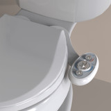 Brondell SouthSpa advanced left-handed bidet attachment with dual nozzle  installed in beige background