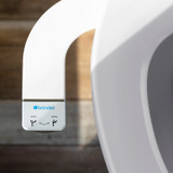 Brondell SimpleSpa bidet attachment with dual nozzle with wood floor background