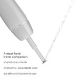Brondell GoSpa Advanced Travel Bidet GS-84/85 gray, inverted spraying water up.  Copy: A must-have travel companion.  angled spray nozzle, ergonomic, squeezable body, durable and discreet design.