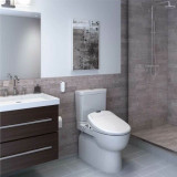 White Brondell Swash 1400 bidet toilet seat installed in a bathroom with the lid closed from a side view