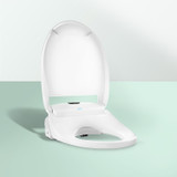 Omigo SL Advanced Bidet Toilet Seat with Remote Control lid open against mint background